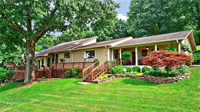 single story home featuring a deck, stairway, and a front lawn