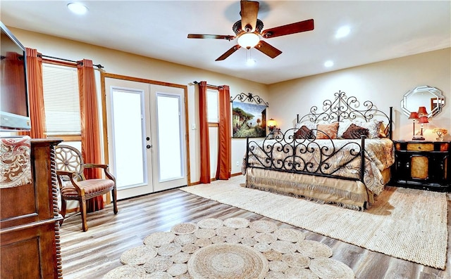 bedroom with access to outside, french doors, wood finished floors, and recessed lighting