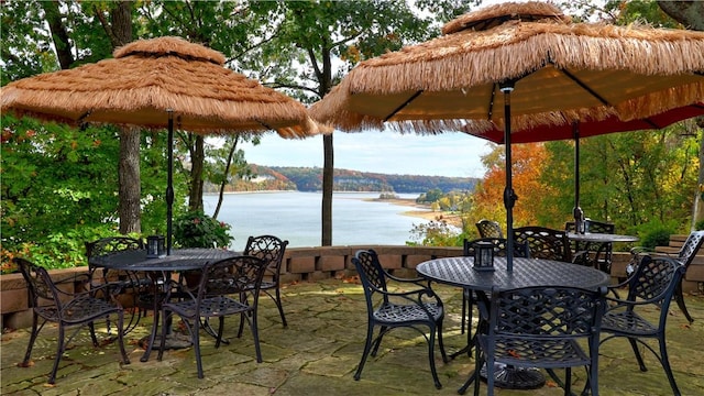 view of patio / terrace with a water view and outdoor dining area