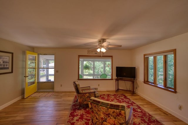 living area with a wealth of natural light and light wood-style flooring