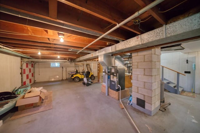 basement with stairway and heating unit