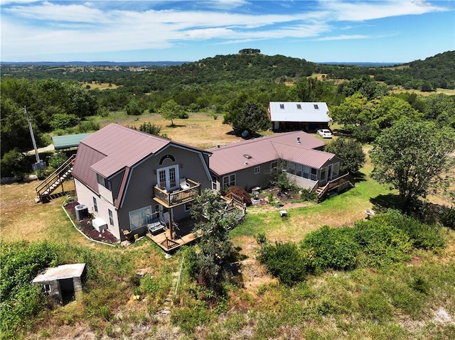 birds eye view of property featuring a wooded view