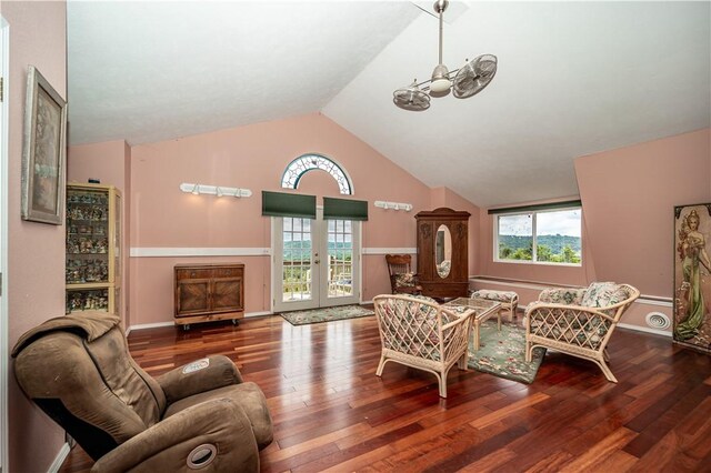 living room with high vaulted ceiling, plenty of natural light, french doors, and hardwood / wood-style floors