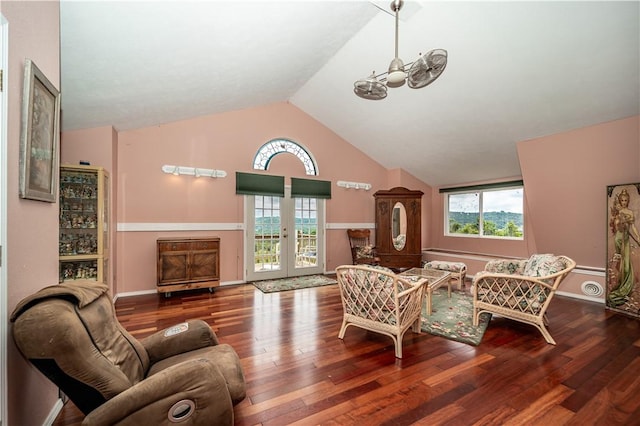 living area featuring plenty of natural light, high vaulted ceiling, wood finished floors, and french doors