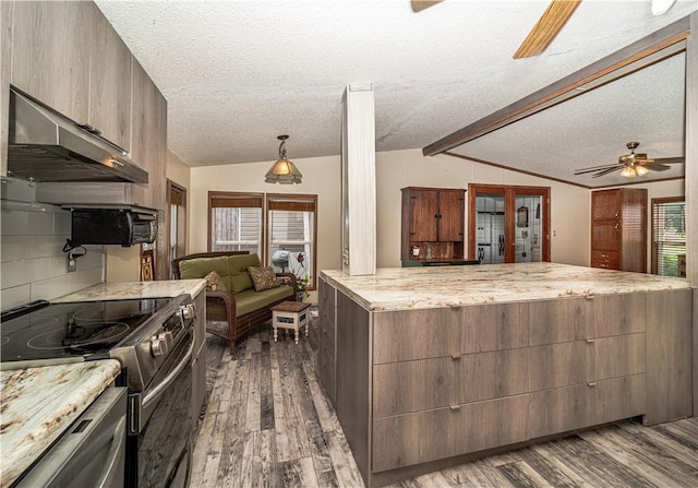 kitchen featuring lofted ceiling with beams, under cabinet range hood, electric range oven, and wood finished floors