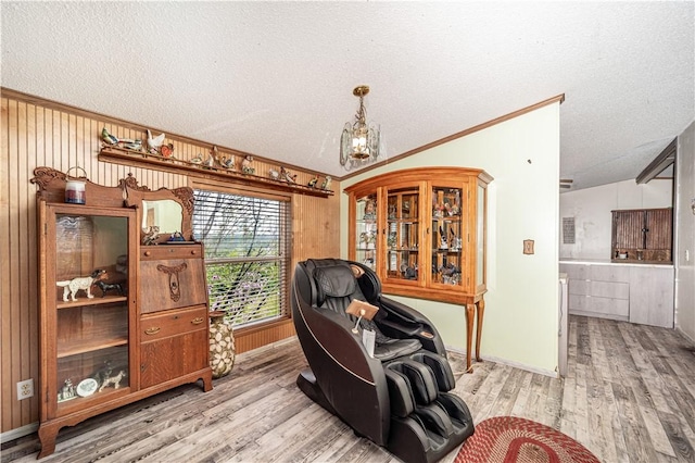 home office with ornamental molding, vaulted ceiling, a textured ceiling, and wood finished floors