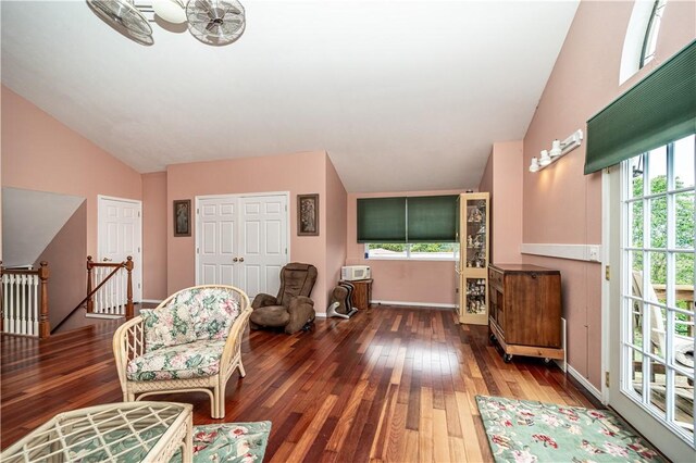 sitting room with a wealth of natural light, dark wood-type flooring, and vaulted ceiling