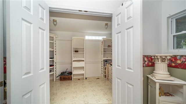 walk in closet featuring light tile patterned flooring