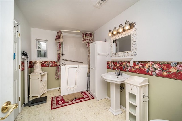 bathroom featuring curtained shower, visible vents, and tile patterned floors