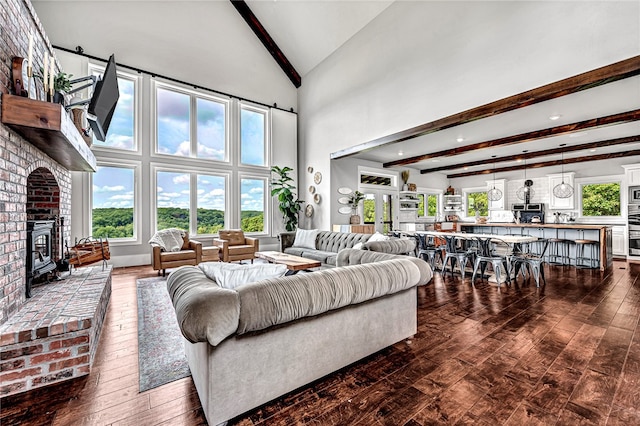 living room featuring dark hardwood / wood-style floors, a fireplace, and high vaulted ceiling