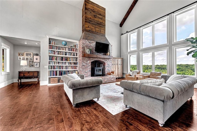 living room with high vaulted ceiling, dark wood-type flooring, beamed ceiling, a fireplace, and baseboards