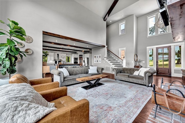 living area featuring high vaulted ceiling, dark wood-style floors, stairs, beam ceiling, and recessed lighting