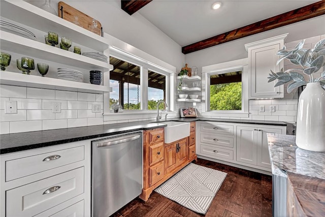 kitchen with stainless steel dishwasher, open shelves, beam ceiling, a sink, and backsplash
