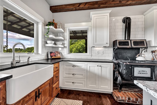 kitchen featuring white cabinets, dark wood-type flooring, tasteful backsplash, and sink