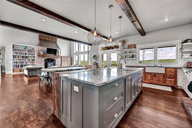 kitchen featuring a sink, gray cabinetry, open shelves, beam ceiling, and recessed lighting