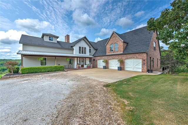 view of front of home featuring concrete driveway, a chimney, a front lawn, covered porch, and a shingled roof