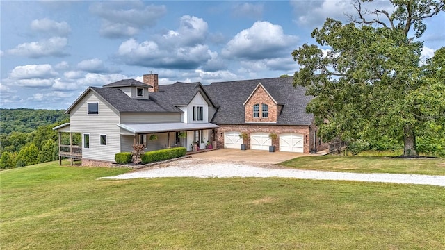view of front facade featuring gravel driveway, a front yard, a chimney, a porch, and an attached garage