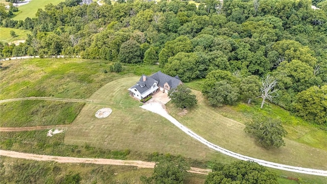 aerial view of property's location with a heavily wooded area