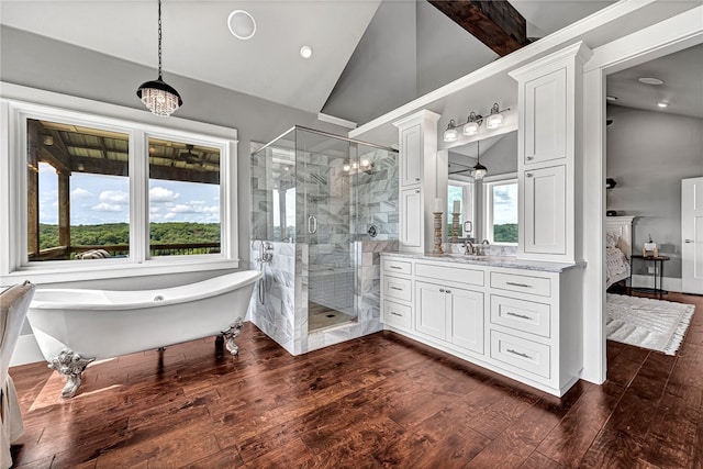 bathroom with hardwood / wood-style floors, independent shower and bath, ornate columns, lofted ceiling, and vanity