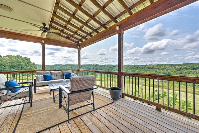 wooden deck with an outdoor hangout area and ceiling fan