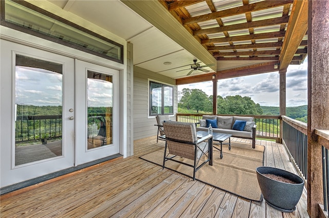 wooden deck with outdoor lounge area, french doors, and ceiling fan