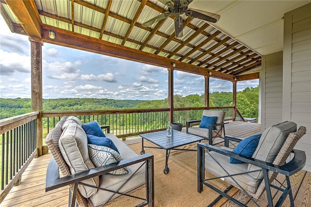 wooden terrace with an outdoor hangout area and ceiling fan