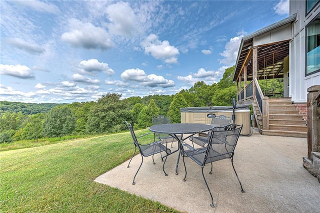 view of patio / terrace with stairway, a view of trees, and outdoor dining space