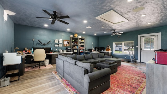 living room with light hardwood / wood-style floors and ceiling fan