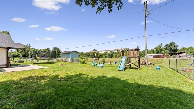 view of yard featuring a trampoline and a playground