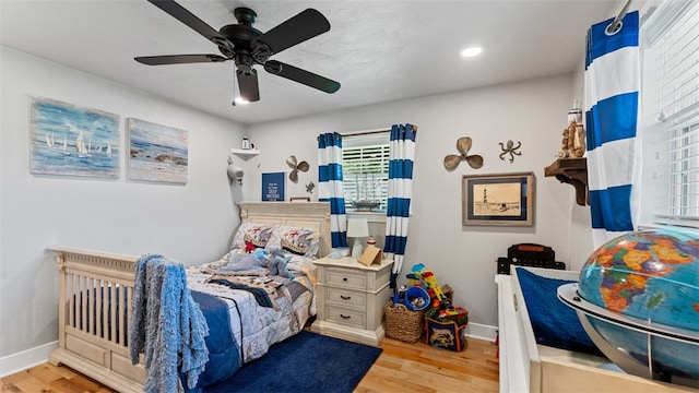 bedroom with light hardwood / wood-style floors and ceiling fan