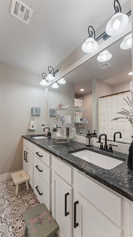 bathroom featuring dual vanity and tile patterned floors