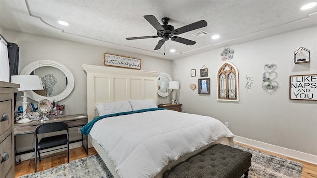 bedroom featuring hardwood / wood-style flooring and ceiling fan