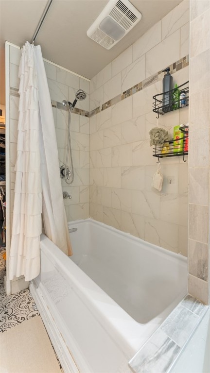 bathroom with tile patterned flooring and shower / bath combo