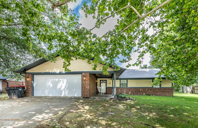 view of front of property featuring a garage and a front lawn