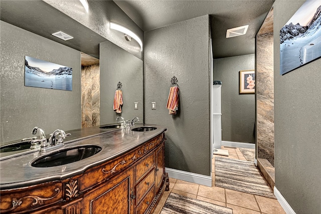 bathroom featuring tile patterned flooring and double vanity