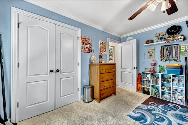 carpeted bedroom featuring ceiling fan, ornamental molding, and a closet