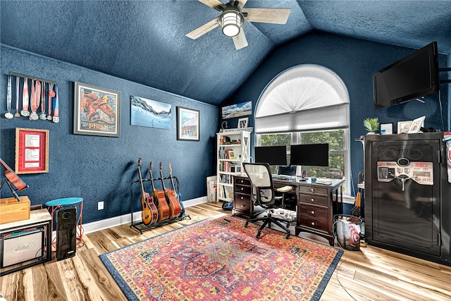 home office with light hardwood / wood-style floors, lofted ceiling, ceiling fan, and a textured ceiling