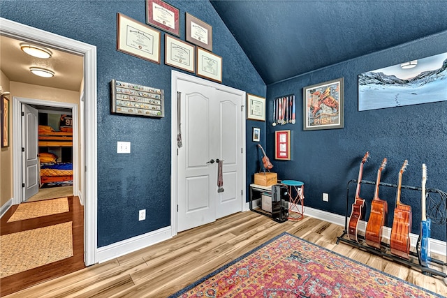 foyer featuring light hardwood / wood-style floors and lofted ceiling