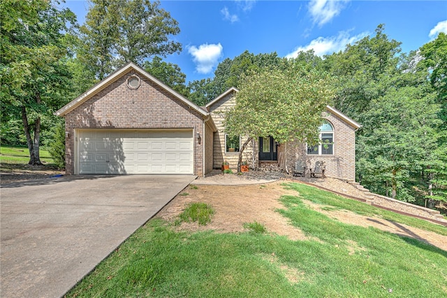 view of front facade with a garage and a front yard