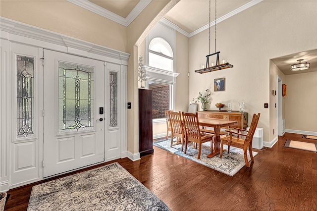 entryway with crown molding and dark hardwood / wood-style flooring