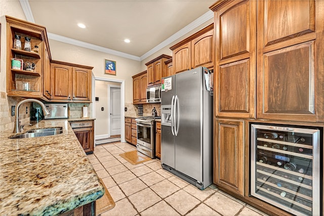 kitchen featuring tasteful backsplash, stainless steel appliances, sink, light stone countertops, and wine cooler