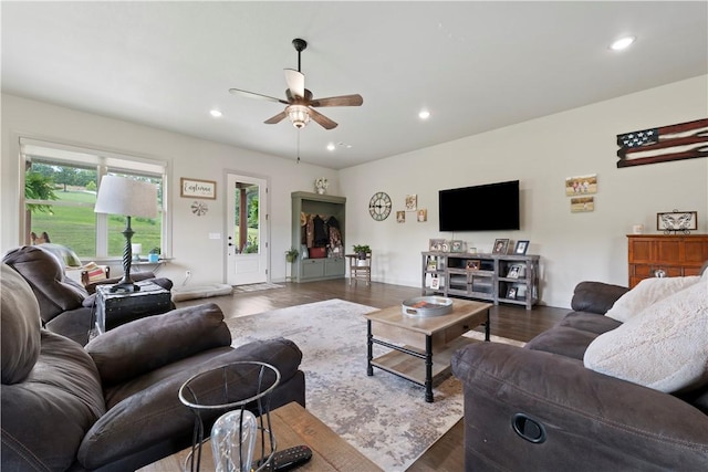 living room with ceiling fan and dark hardwood / wood-style floors