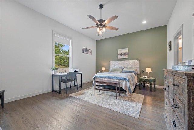 bedroom with ceiling fan and dark hardwood / wood-style floors