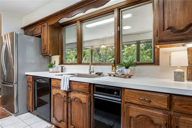 kitchen featuring dishwasher, sink, tasteful backsplash, and light tile patterned flooring