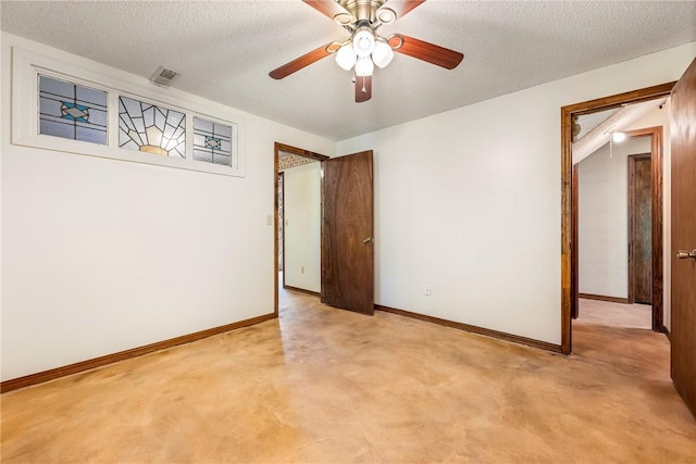 carpeted empty room with ceiling fan and a textured ceiling