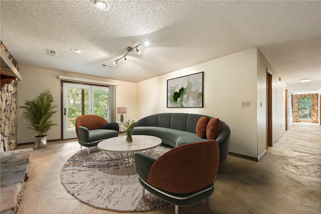 living room featuring concrete flooring and a textured ceiling