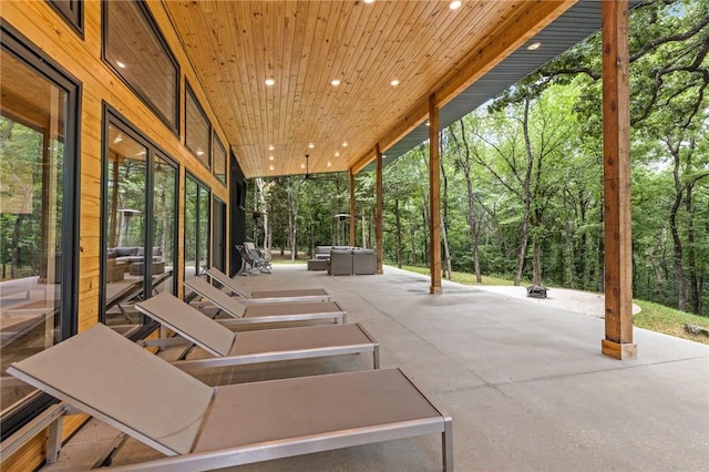 view of patio with an outdoor fire pit and a jacuzzi