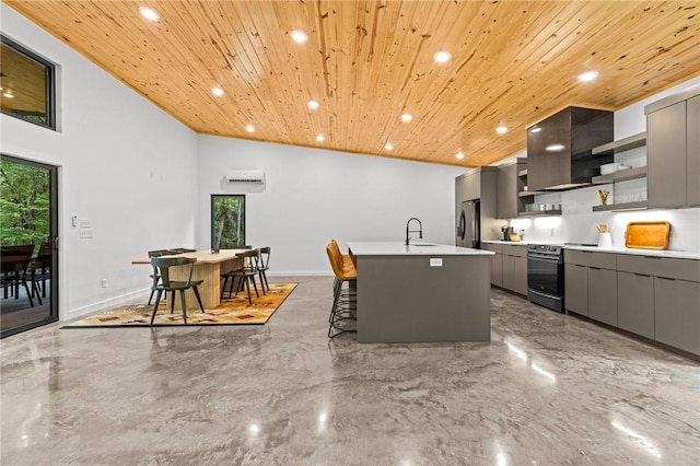 kitchen with a breakfast bar, wooden ceiling, appliances with stainless steel finishes, gray cabinets, and a kitchen island with sink