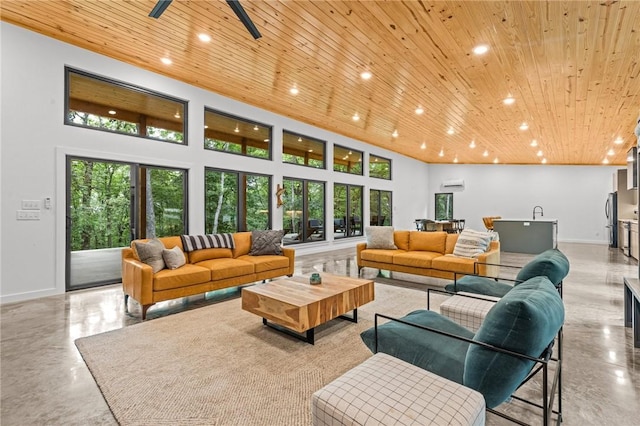 living room featuring wood ceiling and a towering ceiling