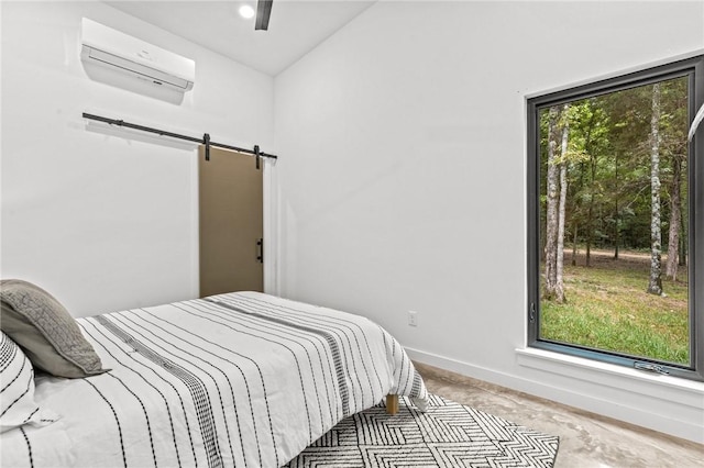 bedroom with a barn door, a wall mounted AC, lofted ceiling, and ceiling fan